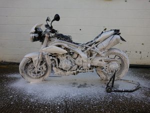Using an industrial de-greaser first, Daniel then used a Snow Foam wash twice to pull as many impurities form the panels, engine casings, wheels & the underbelly of the Triumph.